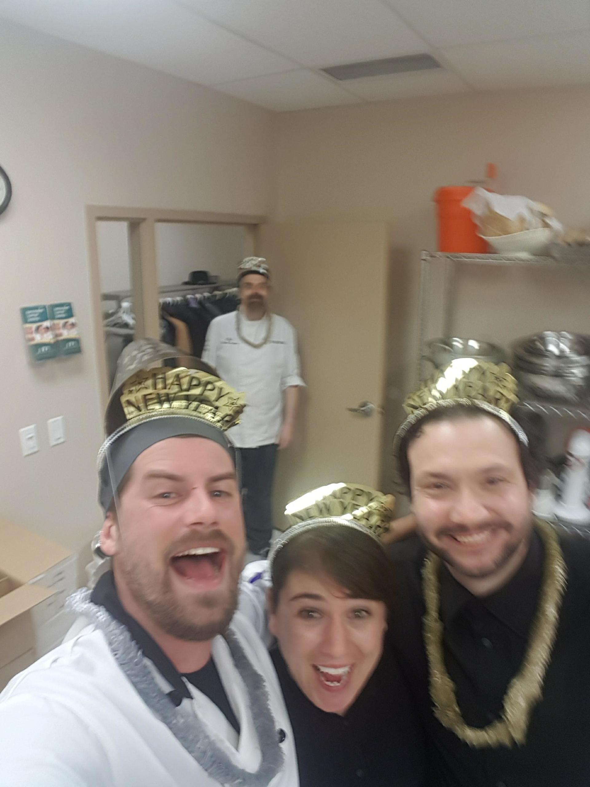 The team celebrating New Year’s Eve in party hats