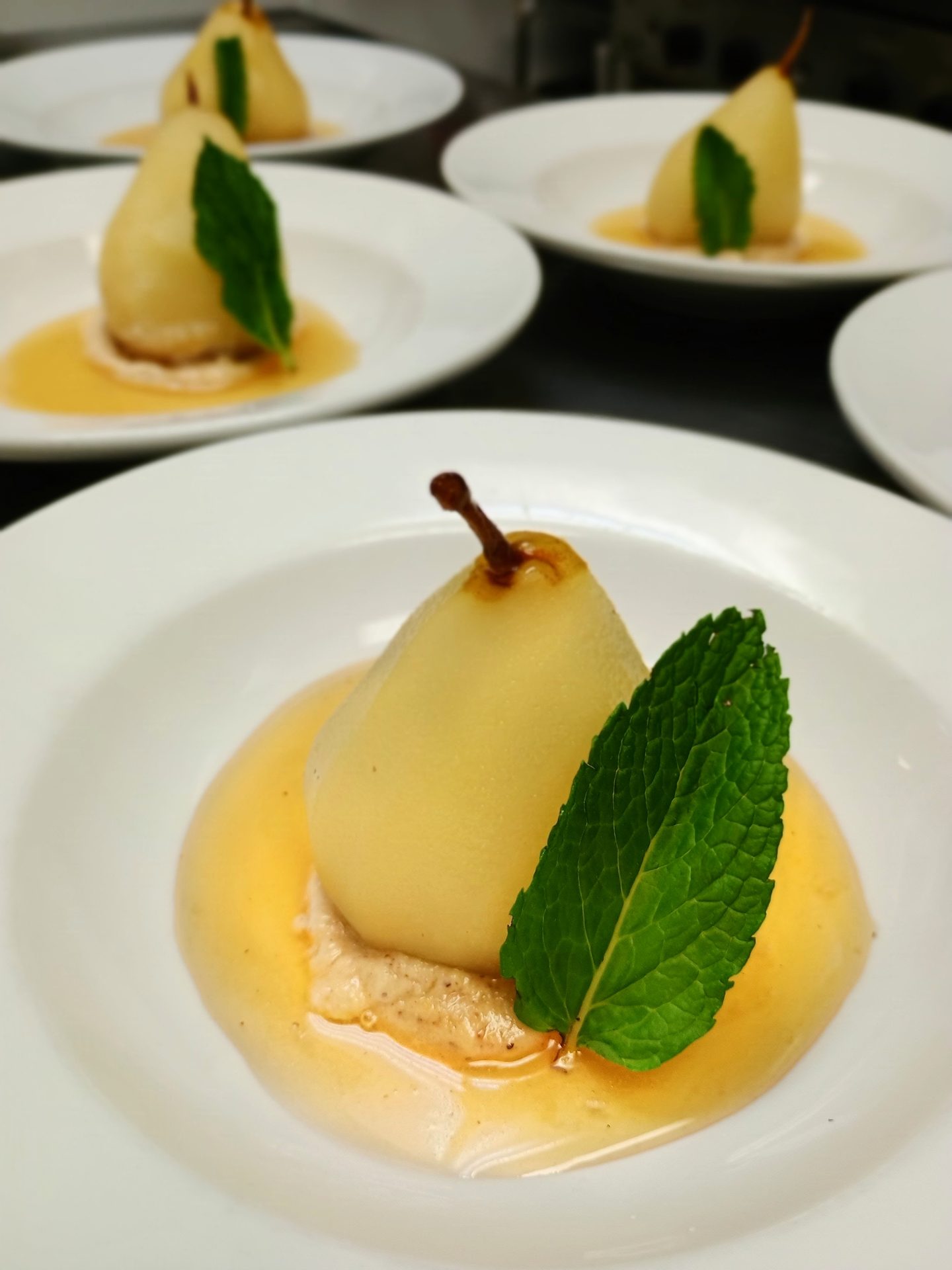 Poached pears with mint, plated for a dinner